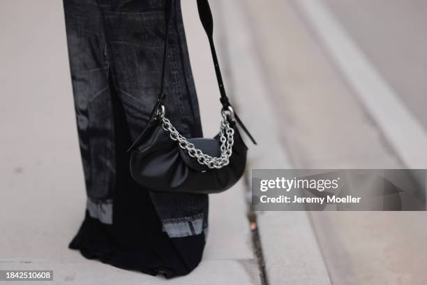 Miki Sui Cheung seen wearing Jean Paul Gaultier black faded denim print pattern cut-outs long dress, THEMOIRè black leather bag, on December 08, 2023...