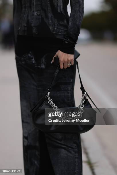 Miki Sui Cheung seen wearing Jean Paul Gaultier black faded denim print pattern cut-outs long dress, THEMOIRè black leather bag, on December 08, 2023...