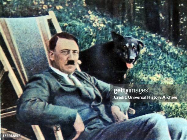 Hitler on vacation with a dog seated adjacent to him 1934