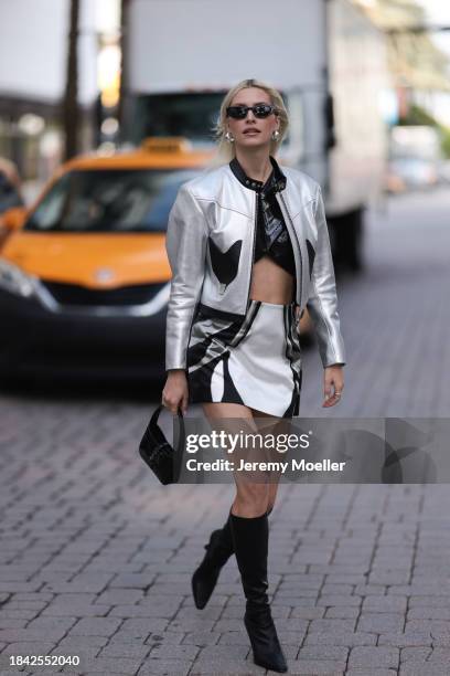 Lena Gercke seen wearing Saint Laurent black sunglasses, silver statement earrings, Louis Vuitton black varnished leather cropped top, Louis Vuitton...