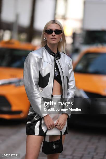 Lena Gercke seen wearing Saint Laurent black sunglasses, silver statement earrings, Louis Vuitton black varnished leather cropped top, Louis Vuitton...