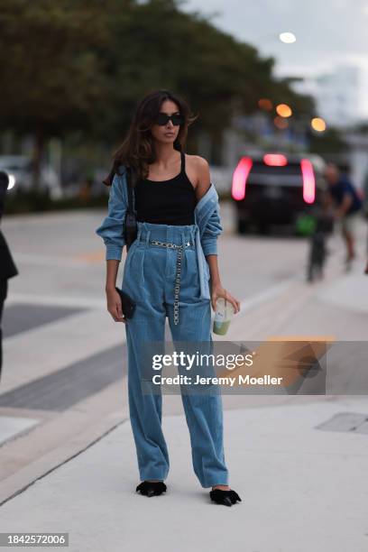 Paris Solati seen wearing black sunglasses, black cotton tanktop, blue corduroy two-piece / blue corduroy shirt jacket, matching blue corduroy long...