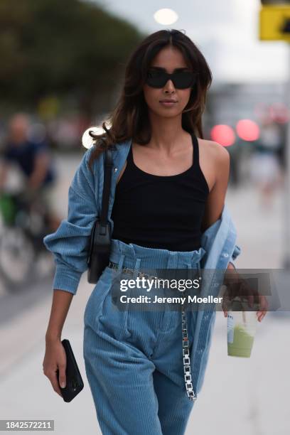 Paris Solati seen wearing black sunglasses, black cotton tanktop, blue corduroy two-piece / blue corduroy shirt jacket, matching blue corduroy long...