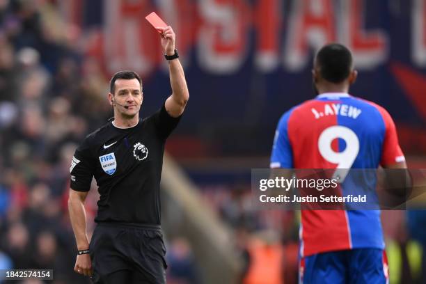 Match Referee Andy Madley shows Jordan Ayew of Crystal Palace a red card during the Premier League match between Crystal Palace and Liverpool FC at...