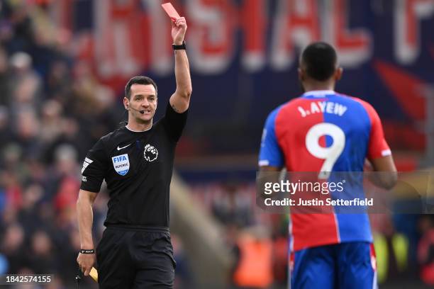 Match Referee Andy Madley shows Jordan Ayew of Crystal Palace a red card during the Premier League match between Crystal Palace and Liverpool FC at...