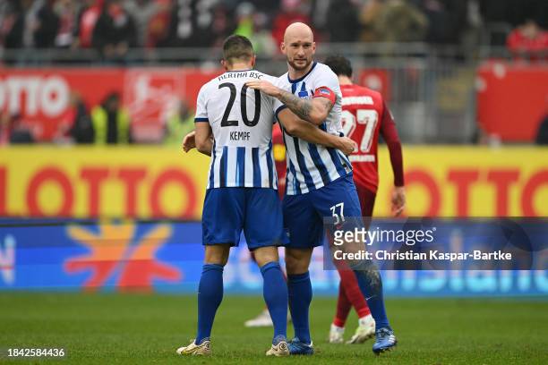 Alexander Schwolow and Aissa Laidouni of 1.FC Union Berlin embrace after the Second Bundesliga match between 1. FC Kaiserslautern and Hertha BSC at...