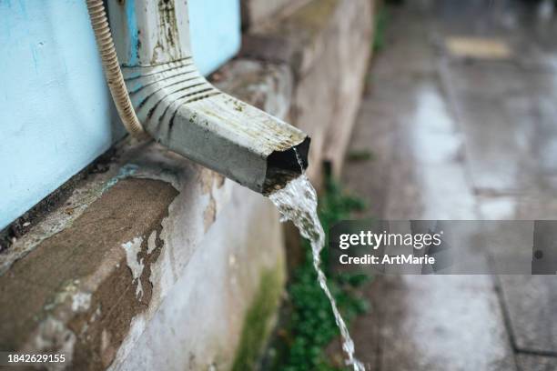 rain gutter with flowing rain water - emitting stock pictures, royalty-free photos & images