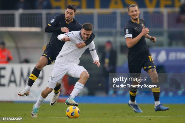 Suat Serdar of Verona holds back Mario Gila of Lazio during the Serie A TIM match between Hellas Verona FC and SS Lazio at Stadio Marcantonio...