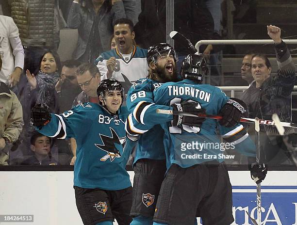 Brent Burns of the San Jose Sharks is congratulated by Joe Thornton and Matt Nieto after he scored the go-ahead goal in the third period of their...