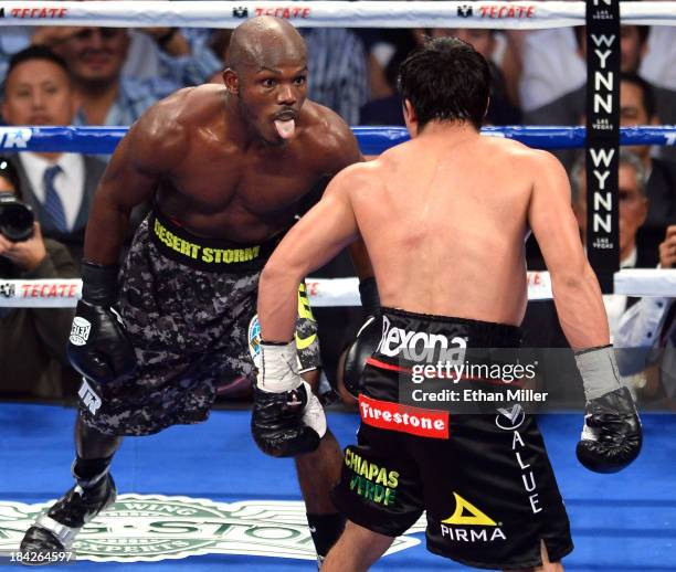 Welterweight champion Timothy Bradley Jr. Sticks his tongue out at Juan Manuel Marquez in the final seconds of the fifth round of their bout at the...