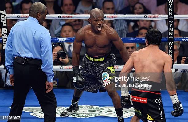 Welterweight champion Timothy Bradley Jr. Sticks his tongue out at Juan Manuel Marquez as referee Robert Byrd looks on in the final seconds of the...