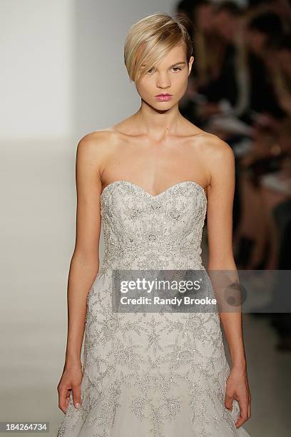 Model walks the runway at the Kenneth Pool Fall 2014 Bridal collection show on October 12, 2013 in New York City.