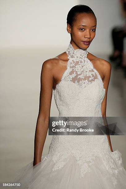 Model walks the runway at the Kenneth Pool Fall 2014 Bridal collection show on October 12, 2013 in New York City.