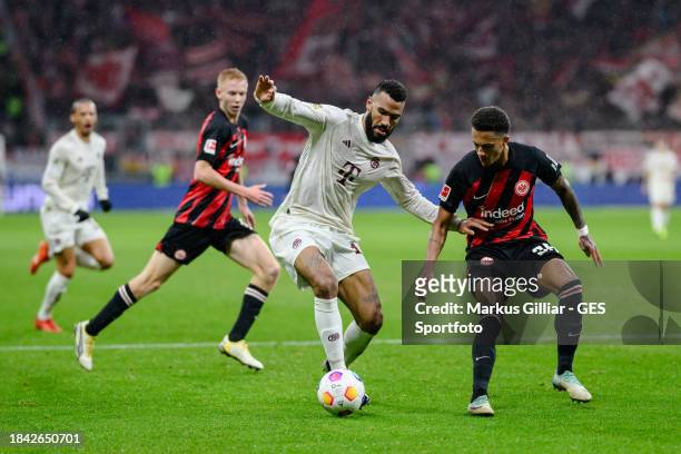 Eric Maxim Choupo-Moting of Munich is tackled by Tuta of Frankfurt during the Bundesliga match between Eintracht Frankfurt and FC Bayern München at...