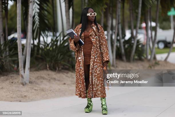 Iyanna Yasmeen seen wearing Gucci white round glasses, brown ruffled short dress, Burberry brown pattern long coat, Louis Vuitton white canvas with...