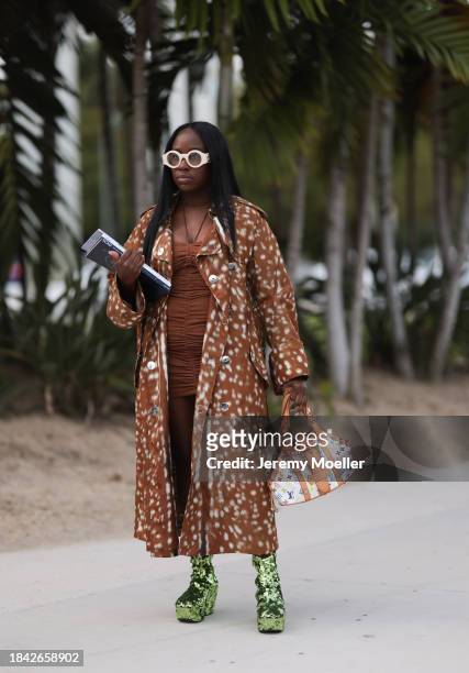 Iyanna Yasmeen seen wearing Gucci white round glasses, brown ruffled short dress, Burberry brown pattern long coat, Louis Vuitton white canvas with...