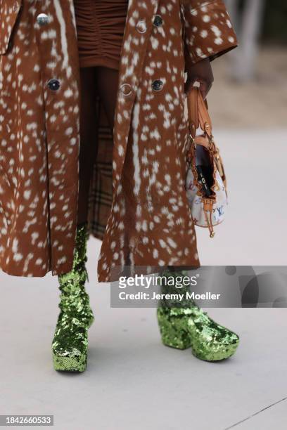 Iyanna Yasmeen seen wearing Burberry brown pattern long coat, Louis Vuitton white canvas with colorful logo print pattern bag and bright green...