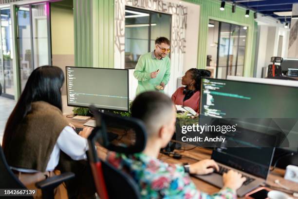 people coding in the modern office - developers talking stock pictures, royalty-free photos & images