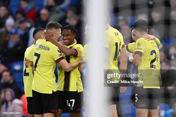 Wilson Odobert of Burnley celebrates with teammates after scoring their team's first goal during the Premier League match between Brighton & Hove...