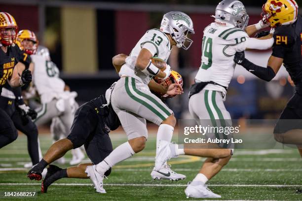 Quarterback Toa Faave of the De La Salle Spartans gets sacked by outside linebacker Jonavan Asuncion of the Mission Viejo Diablos during the CIF...