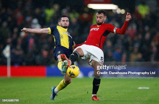 Bruno Fernandes of Manchester United and Lewis Cook of AFC Bournemouth challenge for the ball during the Premier League match between Manchester...