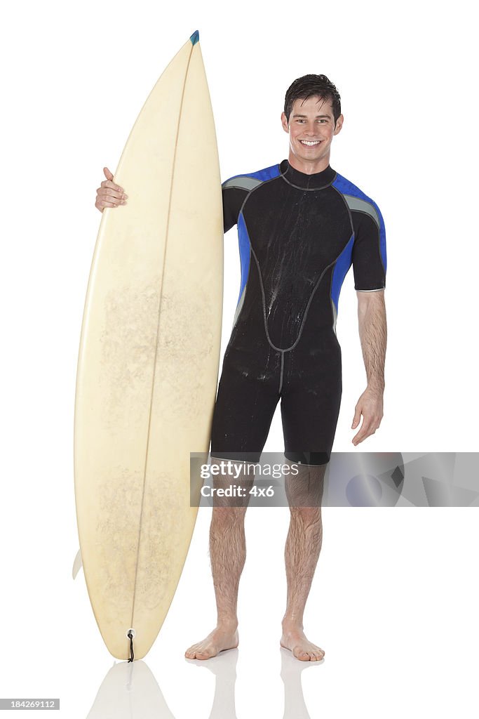 Man standing with a surfboard
