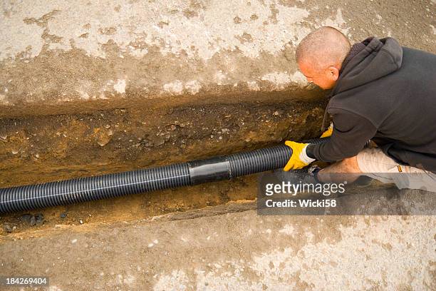 fitting the drain pipes - pvc stockfoto's en -beelden