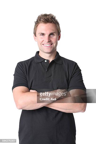 man standing with arms crossed - polo shirt stock pictures, royalty-free photos & images