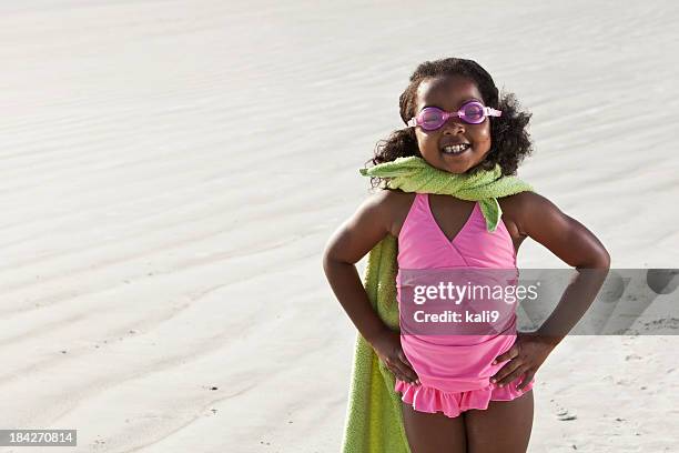 superhero at the beach - young girl swimsuit stockfoto's en -beelden