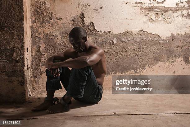 prisoner in a dirty cell - man chained up stock pictures, royalty-free photos & images