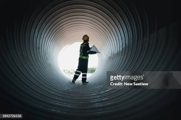 engineers inspecting circular water pipe construction for water, oil, natural gas, and fuel transport pipelines. - lawn aeration stock pictures, royalty-free photos & images