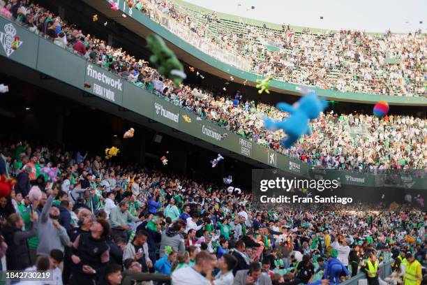 Fans of Real Betis throw stuffed animals on to the pitch for charity at half time during the LaLiga EA Sports match between Real Betis and Real...