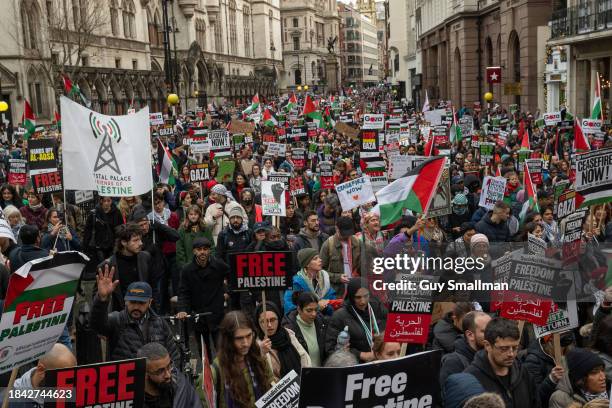 The march proceeds around Aldwych as tens of thousands of people attend the Pro-Palestine demonstration on December 9, 2023 in London, England. A...