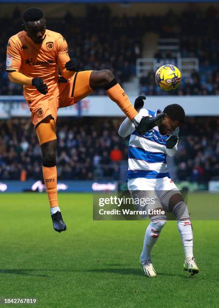 Adama Traore of Hull City jumps against Chris Willock of Queens Park Rangers during the Sky Bet Championship match between Queens Park Rangers and...