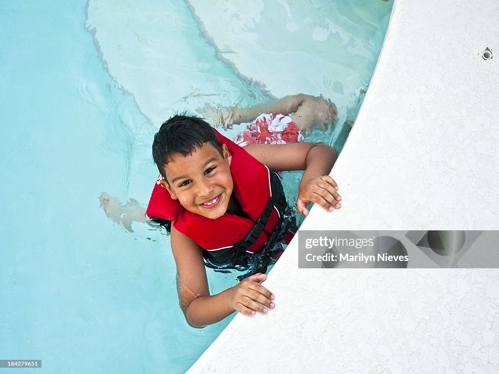 Cute boy swimming