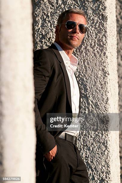man with sunglasses looking up - black suit sunglasses stock pictures, royalty-free photos & images