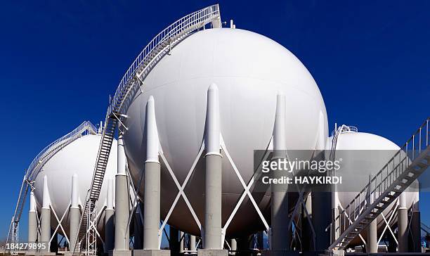 three round holding tanks at petrochemical plant - storage room stock pictures, royalty-free photos & images