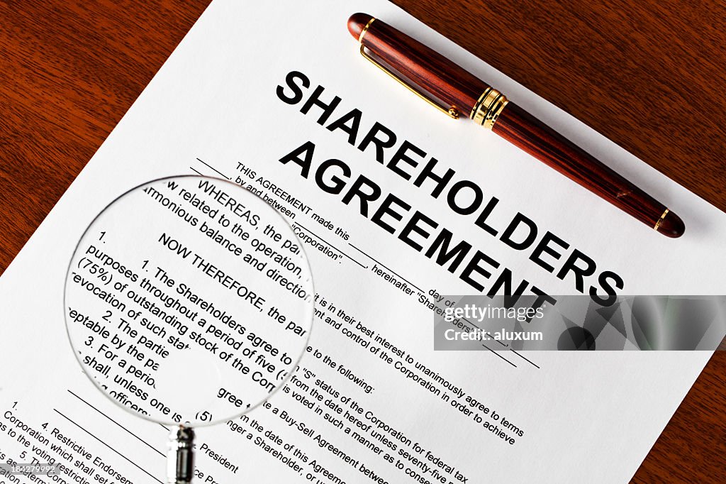 Magnifying glass on shareholders agreement