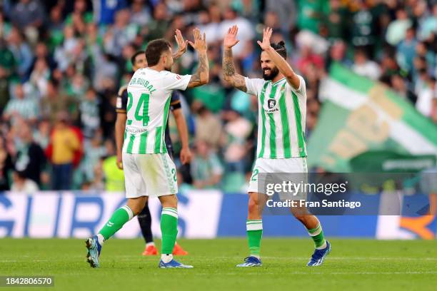 Aitor Ruibal of Real Betis celebrates scoring their team's first goal with team mate Isco during the LaLiga EA Sports match between Real Betis and...