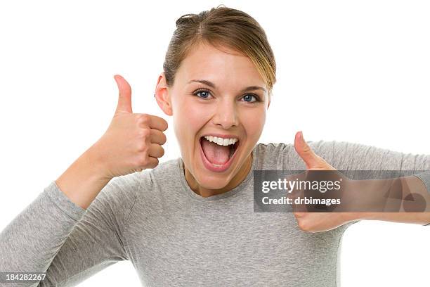 heureux jeune femme offre deux pouce levé - women two thumbs up photos et images de collection
