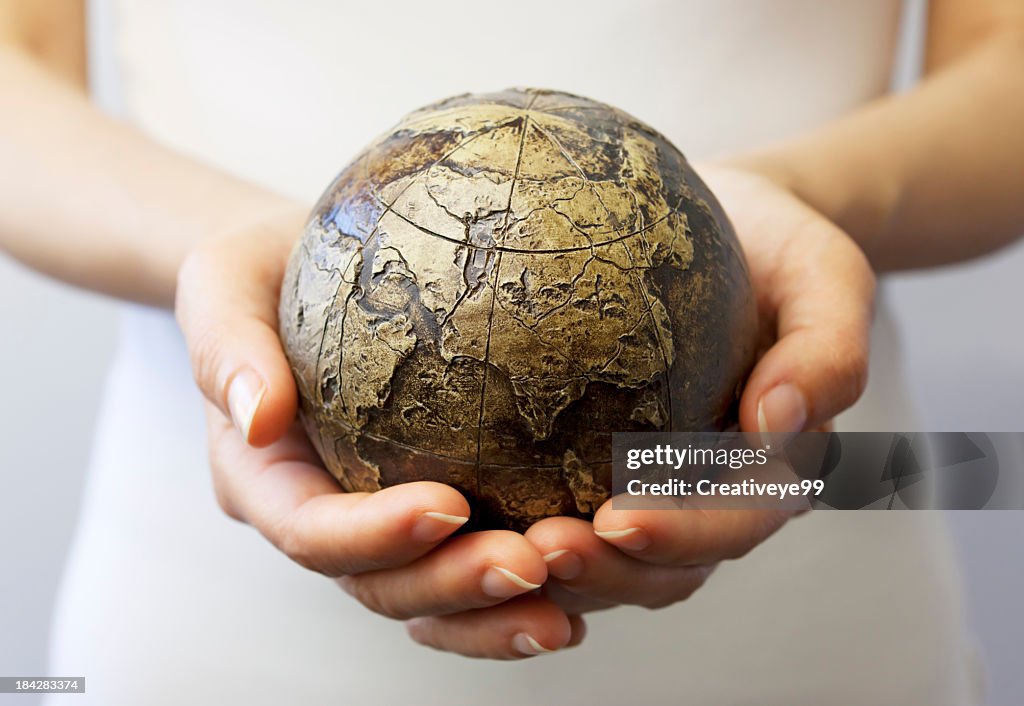Hands holding globe