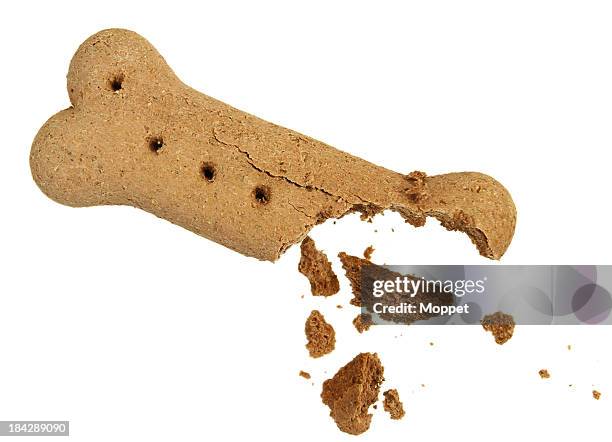half-eaten brown dog biscuit on a white background - dog biscuit stock pictures, royalty-free photos & images