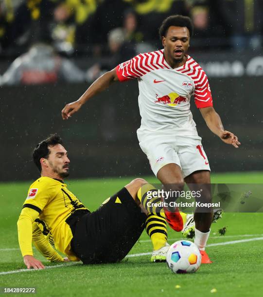 Lois Openda of RB Leipzig is challenged by Mats Hummels of Borussia Dortmund leading to a penalty during the Bundesliga match between Borussia...