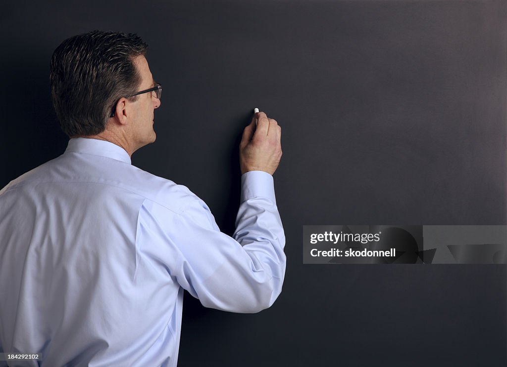 College Professor Against a Chalk Board