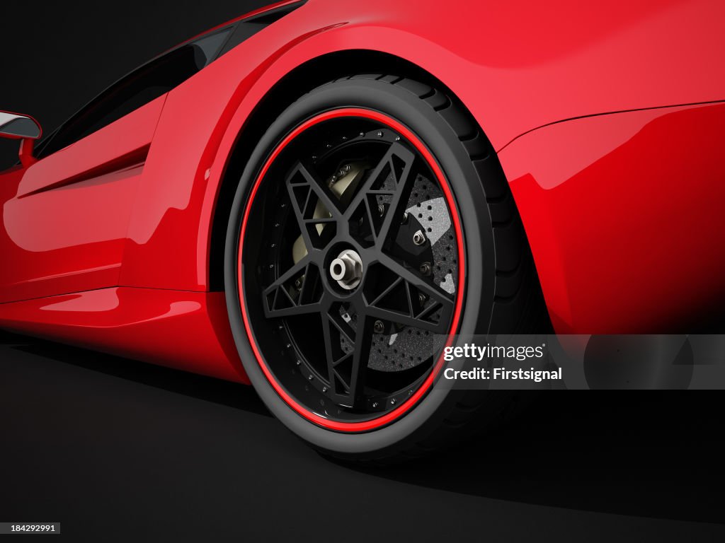 Red sport car on black studio background