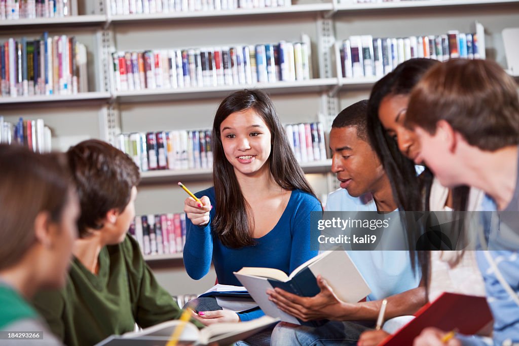 Group of teenage students discussing books