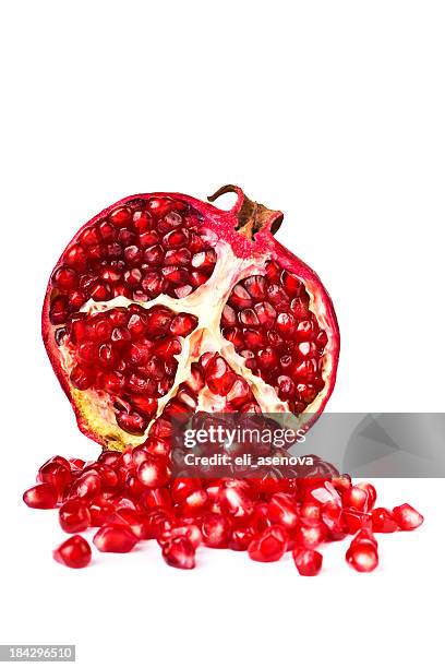 half of a pomegranate on a white background - pomegranate stock pictures, royalty-free photos & images