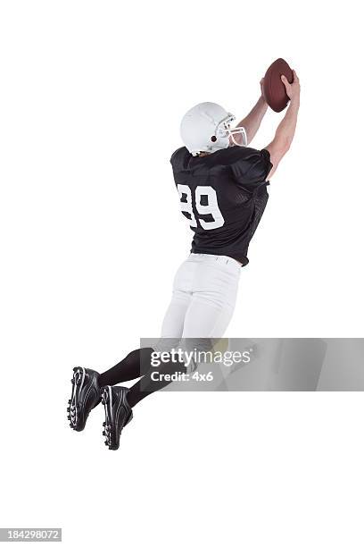 football player in action - american football player back stock pictures, royalty-free photos & images