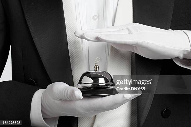 butler holding and about to ring a service bell - hand with bell stockfoto's en -beelden