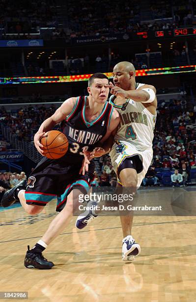 Mike Miller of the Memphis Grizzlies drives against David Wesley of the New Orleans Hornets during the NBA game at New Orleans Arena on February 21,...
